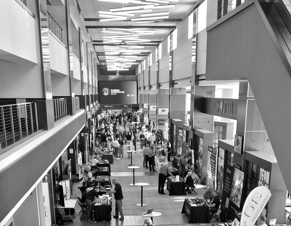 People walking through a technology and automation expo hall