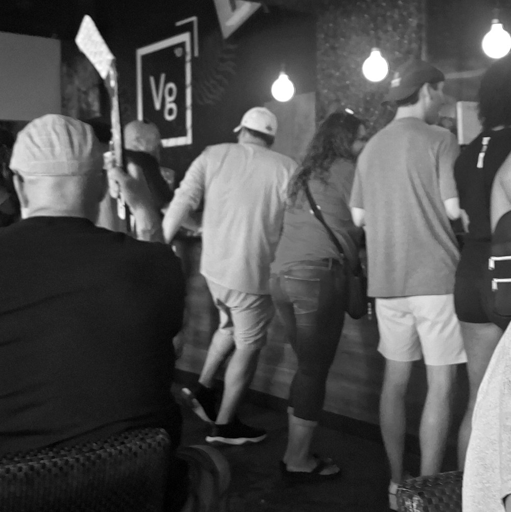 People mingling at a casual community meetup in a local brewery
